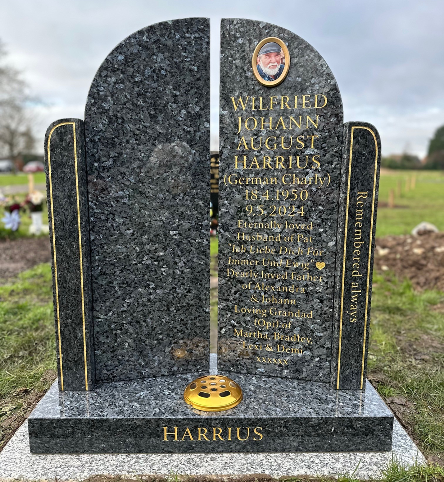 Black granite gravestone with engraved text and photo.